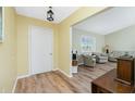 Welcoming entryway featuring wood-look flooring and views into the light and airy living room at 10116 Melanie Ave, Englewood, FL 34224