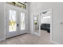 Bright foyer with glass double doors and a view into the living area at 10454 Atenia St, Port Charlotte, FL 33981