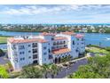This exterior view showcases a condo with lush landscaping, parking, and architectural beauty at 11100 Hacienda Del Mar Blvd # G-304, Placida, FL 33946