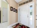 Bright entryway with a neutral color scheme and sidelight windows at 1247 Nora Ln, North Port, FL 34286