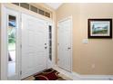 Bright entryway with white doors, side windows, and a decorative rug at 1247 Nora Ln, North Port, FL 34286