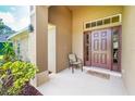 Inviting front porch with a cozy chair and a 'Welcome to our home' doormat at 1247 Nora Ln, North Port, FL 34286