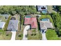 Aerial view showcasing the layout of the property and its proximity to neighboring homes and driveways at 13080 Proctor Ave, Port Charlotte, FL 33981