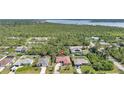 Wide aerial view illustrating neighborhood, tree coverage, and distance to nearby waterways at 13080 Proctor Ave, Port Charlotte, FL 33981