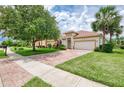 Beautiful single-story home with brick driveway, lush front yard, and a well-maintained lawn at 13282 Scrub Jay Ct, Port Charlotte, FL 33953