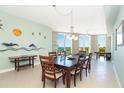 Spacious dining room with stylish furniture and water views from the bright, sunlit windows at 1375 Beach Rd # 201, Englewood, FL 34223