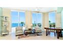 Bright living room boasts water views from three large windows, stylish furnishings, and tiled floors at 1375 Beach Rd # 201, Englewood, FL 34223