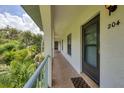 Balcony view of lush tropical landscaping at 1730 Manasota Beach Rd # 204, Englewood, FL 34223