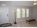 Bright living room with neutral walls, tile flooring, and multiple large windows at 21 Sportsman Way, Rotonda West, FL 33947