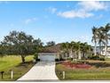 Charming single-story home with well-maintained landscaping, mature trees, and a spacious two-car garage at 2295 Chilcote Ter, Port Charlotte, FL 33981