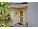 Inviting front entrance with a decorative starfish accent and tropical foliage surrounding the doorway at 232 Southampton Ln # 259, Venice, FL 34293