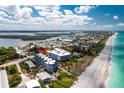 Stunning aerial view of a beachfront condo complex with turquoise waters and the white sands, highlighting its coastal location at 2380 N Beach Rd # 210, Englewood, FL 34223