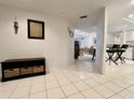 Bright hallway leading to a stylish kitchen and dining area, featuring neutral tiled floors and contemporary decor at 2380 N Beach Rd # 210, Englewood, FL 34223