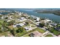 Breathtaking aerial view of waterfront homes highlights the serene location and coastal charm of this lovely neighborhood at 310 Green Dolphin Dr, Placida, FL 33946