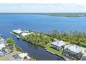 Aerial view showcases waterfront property, community access, and beautiful blue ocean water at 4219 Spire St, Port Charlotte, FL 33981