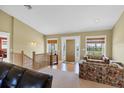 Inviting living room features hardwood floors, large windows, and a beautiful wood staircase at 4219 Spire St, Port Charlotte, FL 33981