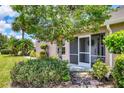Charming single-story home with screened front porch and lush landscaping at 4225 Fairway Dr, North Port, FL 34287