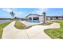 Backyard featuring a pool, patio, and waterfront access, perfect for outdoor enjoyment at 5174 Conner Ter, Port Charlotte, FL 33981