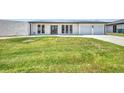 Well-maintained home with a manicured lawn and a concrete driveway leading to a garage at 5174 Conner Ter, Port Charlotte, FL 33981