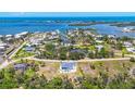 Aerial view of waterfront community with stunning bay views in the distance at 530 Spaniards Rd, Placida, FL 33946