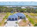 Gorgeous exterior of a single-Gathering home with a three-car garage and lush landscaping at 530 Spaniards Rd, Placida, FL 33946