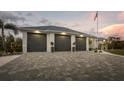 Spacious three-car garage with paver driveway and well-maintained landscaping at 530 Spaniards Rd, Placida, FL 33946