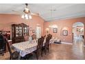 Elegant dining room featuring a decorative hutch, chandelier, and neutral tiling at 5510 Moongate Rd, Spring Hill, FL 34606