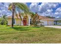 Single-story home featuring a well-maintained lawn, palm trees, and an inviting entrance, perfect for Florida living at 59 White Marsh Ln, Rotonda West, FL 33947