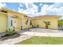 Close up of a well maintained single-story home featuring a welcoming front entrance with outdoor seating at 6158 Cavan St, Englewood, FL 34224