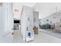 Bright foyer with decoratively displayed ladder shelf, vaulted ceilings and entry to dining and living areas at 7048 Inland St, Englewood, FL 34224