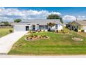 Charming single-story home boasts a well-manicured lawn with beautiful landscaping and a circular driveway at 7048 Inland St, Englewood, FL 34224
