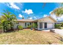 Charming single-story home with well-manicured landscaping and an attached two-car garage at 7247 Brookhaven Ter, Englewood, FL 34224