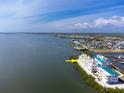 Waterfront condo complex showcasing stunning views and lush landscaping on the water at 8005 Bay Pointe Dr, Englewood, FL 34224