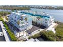 Modern condo exterior with palm trees, ample parking, and sleek architectural design at 8005 Bay Pointe Dr, Englewood, FL 34224