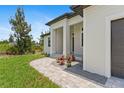 A paved walkway leads to a modern, stylish home with a two-car garage at 8105 Antwerp Cir, Port Charlotte, FL 33981