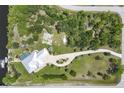 Aerial view of a home with a private dock, pool, well-manicured landscaping, and a long driveway at 8127 Consul St, Port Charlotte, FL 33981