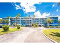 This condo community features a blue color scheme, covered parking, and well maintained landscaping at 8405 Placida Rd # 406, Placida, FL 33946