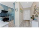 Modern condo kitchen with stainless steel appliances, blue cabinets, and backsplash at 8405 Placida Rd # 406, Placida, FL 33946