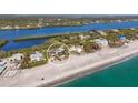 Scenic aerial shot of a coastal home with waterfront views, highlighting its proximity to the beach and river at 8500 Manasota Key Rd, Englewood, FL 34223
