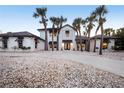 Elegant two-story home with lush landscaping, a circular driveway, and a welcoming entrance at 8500 Manasota Key Rd, Englewood, FL 34223