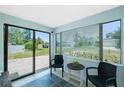 The light and airy patio offers serene views of the front yard, and features tile floor and neutral paint at 859 E 2Nd St, Englewood, FL 34223