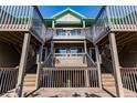 Exterior view showcasing the architecture of the wooden decks and staircase at 9200 Little Gasparilla # 203, Placida, FL 33946