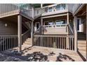 Coastal home featuring multiple wooden decks and staircase, perfect for outdoor living at 9200 Little Gasparilla # 203, Placida, FL 33946