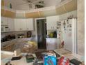 Outdated kitchen with white cabinets and appliances needing updating at 1 Clubhouse Rd, Rotonda West, FL 33947