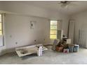 Bare room featuring paint buckets, a sink, and windows allowing natural light at 1 Clubhouse Rd, Rotonda West, FL 33947