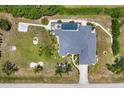 Overhead view of property, showing a large house, spacious layout, pool, generous landscaping, and circular driveway at 1002 Rotonda Cir, Rotonda West, FL 33947