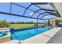 Sparkling pool with screened enclosure and golf course view at 1002 Rotonda Cir, Rotonda West, FL 33947