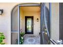 Inviting foyer with tiled flooring, decorative accents, and an elegant front door with a glass insert at 1040 Caples St, Englewood, FL 34223