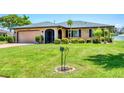 Attractive single-Gathering home boasting a well-kept lawn, mature landscaping, and a welcoming facade at 1040 Caples St, Englewood, FL 34223