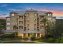 Condominium complex with balconies and a well-maintained landscape, promising a luxurious living experience at 10521 Amberjack Way # 303, Englewood, FL 34224